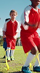 Children, jump and soccer practice on field for agility training, balance exercise and sports workout. Kids, running and equipment for playing game, learning skills and team fitness of match activity