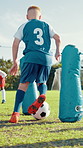 Boy, run and ball for soccer practice for dribble, team training and fitness exercise. Kids, equipment and drill for net defence of sports workout, skills technique and learning agility of challenge