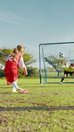 Penalty, kick or girl soccer player with goal for winning at game or match in kids tournament. Sports, exercise or back of football athlete shooting ball in net at target practice on field at stadium
