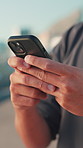 Phone, typing and hands of man in city for social media, internet and networking in urban town. Closeup, street and person on smartphone for website, online connection and message notification