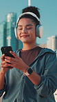Phone, fitness and woman with headphones in city for music, streaming podcast and laughing at meme. Happy athlete, mobile and outdoor for sound, song and runner listening to audio on exercise break