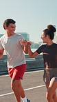 City, people and fist bump for workout, wellness challenge and training for marathon on bridge. Woman, man and friends running with endurance for exercise, cardio and morning jog on road with fitness