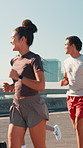 City, group and friends for fitness, wellness challenge and training for marathon on bridge. Women, man and running people with endurance for exercise, cardio and morning jog on road with workout