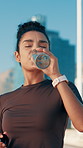 Drinking water, break and woman for exercise, training and runner health for cardio or marathon in city. Hydration, athlete and challenge with energy in street for sports fitness, workout or wellness