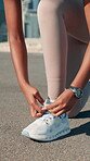 Hands, runner and tie shoes in road to start exercise, running preparation or marathon training in city. Fitness, person and getting ready with sneakers outdoor for cardio workout or race performance