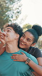 Outdoor, couple and piggyback with pointing for fitness, sightseeing and bonding with conversation. Nature, carrying and man with woman for relationship, exercise break and walking with laughing