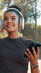 Running, headphones and music with woman in nature for streaming, marathon practice and training. Workout, podcast and exercise with person outdoor for speed challenge, audio and cardio performance
