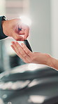 Hands, customer and salesman with keys at car dealership for vehicle purchase, transport hire and test drive. Showroom, person and deal with buyer for automobile collection, rental agreement or offer