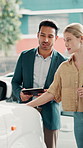 Car dealership, tablet and salesman in showroom with woman for vehicle info, details and features. Digital tech, retail and person with customer for negotiation, discussion and decision for purchase