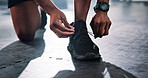 Person, hands and gym with tying laces for workout preparation, exercise or training on floor. Closeup, active or runner getting ready with shoe or tie for start, fitness or wellness at health club
