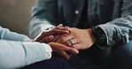 Empathy, couple and holding hands with support in home for mental health, assurance or kindness. Closeup, people and comfort on sofa with sympathy, connection and understanding with healing and grief