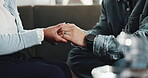 Empathy, couple and holding hands with support on sofa for compassion, mental health and assurance. Closeup, people and comfort in home with sympathy, connection and kindness with healing and trust