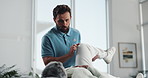 Injury, knee or stretching with patient and physiotherapist in office for assessment. Health, medical or rehabilitation with chiropractor and man in session for accident, emergency or recovery