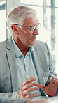 Business, meeting and man in office, conversation and planning for budget report. Mature person, employee and financial advisor in workplace, cooperation and feedback for profit growth and accounting