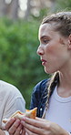 Hiking, friends and women with food, forest and lunch break on journey in woods, adventure and trip. Outdoor, camping and people with sandwich, hungry or girls with healthy meal on vacation or eating