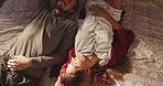 Romance, couple and relax on bed in home, above and comfortable on free time, bedroom and apartment. Rest, man and bonding with woman on honeymoon, break and happy for commitment in relationship