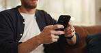 Hands, phone and man on sofa in home with networking, contact or social media scrolling. Notification, technology and male person with cellphone for connectivity, online or mobile app in living room.