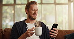 Coffee, phone and man on sofa in home with networking, contact or social media scrolling. Cappuccino, relax and male person with cellphone for connectivity, online or mobile app in living room.