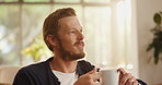 Thinking, coffee and man on sofa in home for calm, relaxing and peaceful morning on weekend. Smile, chilling and male person with cup of warm beverage, tea or latte in living room at apartment.