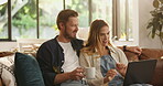 Couple, relax and typing on laptop at house for browsing website, watching movie and streaming film. People, coffee and online for media research, surfing internet and multimedia for entertainment