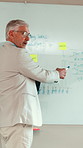 Mature, businessman and presentation with whiteboard in meeting for graph, chart or statistics. Man, employee or speaker with information for company performance, data review or progress at workplace