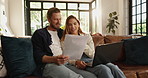 Paperwork, laptop and couple on sofa in home for planning budget, savings or investment account. Discussion, document and man with woman for finance report with computer for paying bills together.