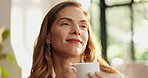 Thinking, coffee and woman on sofa in home for calm, relaxing and peaceful morning on weekend. Smile, daydreaming and female person with cup of warm beverage, tea or latte in living room at apartment