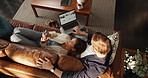 Above, laptop and couple on sofa, smartphone and online reading with website info. House, relax and man with woman, computer and cellphone with social media, chatting and weekend break in lounge
