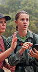 Women, friends and hiking with phone, direction and digital map for location, thinking and confused in woods. People, smartphone and mobile app for search, path and lost with trekking in Argentina