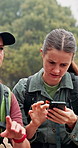 Women, friends and hiking with phone, lost and digital map for location, thinking and confused in woods. People, smartphone and mobile app for direction, path and problem solving with trekking in USA