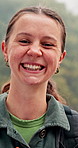 Face, hiking and happy woman in nature for travel, vacation and exploration on adventure. Portrait, smile and female person trekking in woods outdoor for backpacking, holiday or eco tourism in France