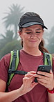 Happy woman, hiker and browsing with phone in nature for navigation, communication or location app. Female person, research or smile with mobile smartphone for hiking route, trekking path or distance
