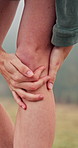 Person, hands or hiker with knee pain or injury for joint inflammation, discomfort or accident. Closeup, hiking or trekking with sore leg, ache or cramp for muscle tension, bruise or sprain in nature