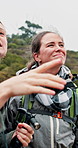 Happy women, hiking or pointing with view on mountain for outdoor adventure or sightseeing together. Female people, friends or hikers with smile for trekking trip, journey or destination in nature
