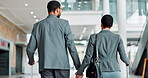 Business, walking and black couple holding hands at airport for global trip, work holiday or travel. Back, professional people and luggage for international flight, corporate opportunity and support