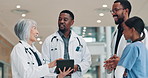 Tablet, team and doctors talk in hospital for healthcare, planning or meeting with mentor. Happy people, technology and discussion with medical group for report, telehealth update or clinic schedule