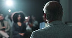 Press conference, speaker and person with motivation for crowd, talking or public speaking on stage. Presentation, back and politician with announcement for audience, speech and official event