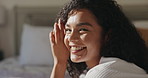 Happy woman, face or relax on bed for spa day or beauty treatment at luxury hotel or resort. Portrait, female person or lying with smile or satisfaction in bedroom for morning, comfort or vacation