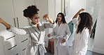 Happy women, friends and dancing in bathroom at spa for energy or satisfaction together at resort. Excited, female people or group in joy with face mask for morning beauty treatment at luxury hotel