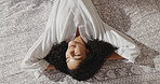 Top view, relax and happy woman in bed with bathrobe at hotel for comfort, resting and morning peace. Thinking, person and lying in bedroom above at spa for calm, wellness and dream with hospitality