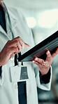 Browsing, scientist and hands with tablet, lab and medical research for treatment, online or cancer. Clinic, oncologist and person with tech for analysis, diagnosis and digital records for illness