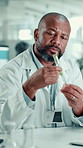 Biotechnology, black man and plant with test tube in laboratory for botany, medical research and breakthrough. Scientist, chemist and examine sample leaf for pharmaceutical or sustainable ecology