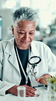 Scientist, woman and plant with magnifying glass in laboratory for botany, medical research and smile. Mature doctor, biotechnology and examine sample for pharmaceutical study or sustainable career
