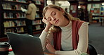 Tired, woman and student sleeping in library for studying, learning burnout and academic exhaustion. Female person, fatigue and nap with laptop for research, information and brain fog from overworked