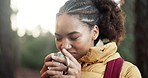 Woman, hiking and smell coffee in forest with backpack, thinking or sightseeing on trail in summer. African person, smile and reflection with warm drink, aroma or trekking in wood on path in Nigeria
