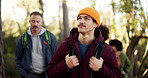 Hiking, man and friends with explore in forest for travel adventure, sightseeing or nature scenery. Backpacker, wellness and group with backpack in woods for holiday journey, fresh air and reflection