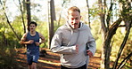 Man, friends and trail running in forest for fitness, challenge and training with smile in summer. People, woman and group with workout, exercise and happy on path in woods for wellness at park