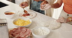 Hands, friends and cooking with dough in kitchen for meal prep, homemade pizza and bonding. People, helping and spreading sauce for traditional lunch, culinary skills and explaining process at house