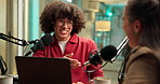 Podcast host, guest and microphone with laughing for funny interview, story joke or discussion. Live streaming, laptop and radio presenter with woman in studio for talk show or comic on air recording
