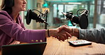 Radio, interview and people in studio, handshake and welcome to talk show for live stream or online. Media production, journalist and shaking hands with man, greeting and woman with mic for podcast